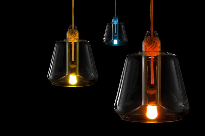 Group shot on black background showing three illuminated Knot lights in blue, yellow and orange.